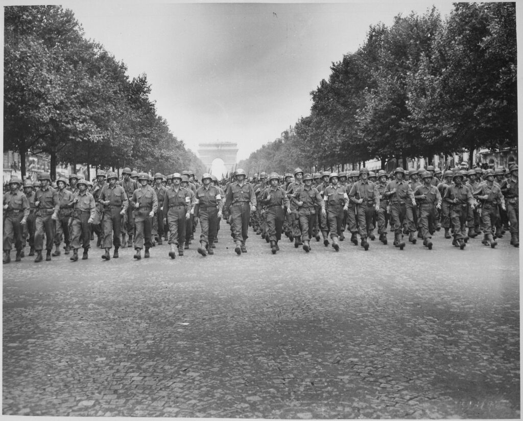 American troops of the 28th Infantry Division march down the Champs Elysees, Paris, in the "Victory" Parade. National Archives Catalog. Liberation of France, Friends of Fondation de France